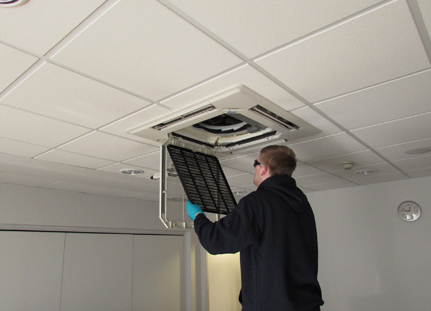 Engineer servicing a commercial air conditioning unit.
