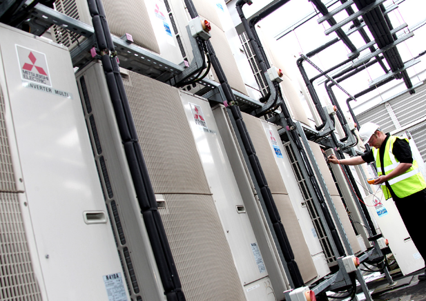 Universal Cooling engineers installing commercial air conditioning.